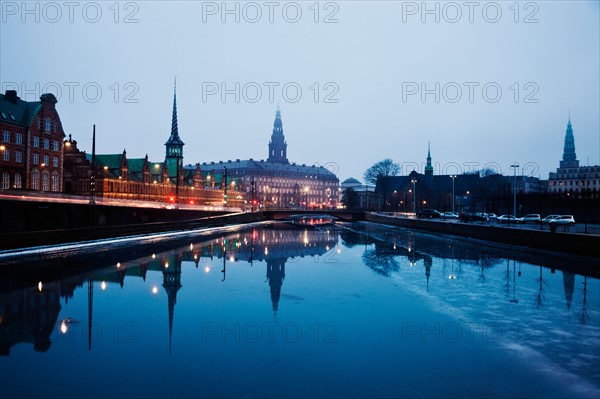 Denmark, Copenhagen. View over canal towards Copenhagen Stock Exchange and Christiansborg Castle. Photo : Henryk Sadura