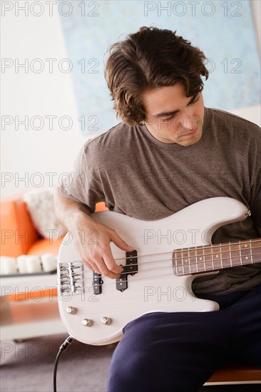 Young man playing electric guitar. Photo : Rob Lewine