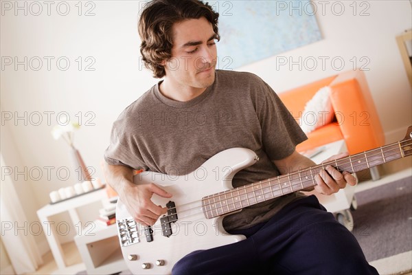 Young man playing electric guitar. Photo : Rob Lewine