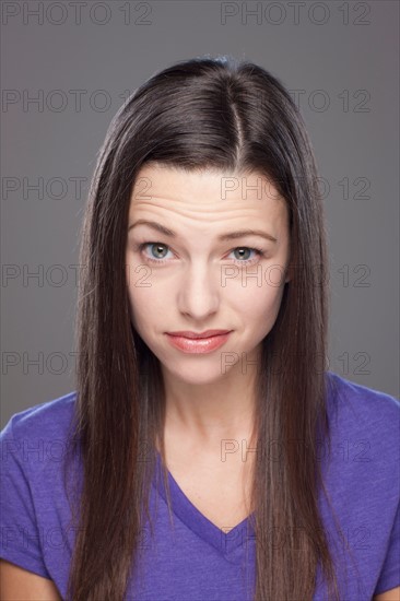 Studio shot of bored young woman. Photo : Rob Lewine