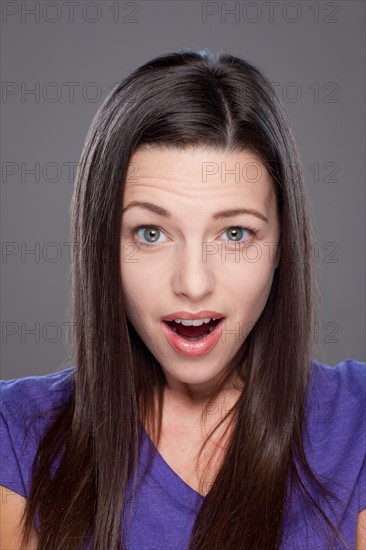 Studio shot of surprised young woman. Photo : Rob Lewine