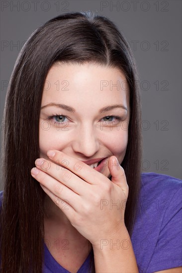 Studio shot of smiling young woman. Photo : Rob Lewine