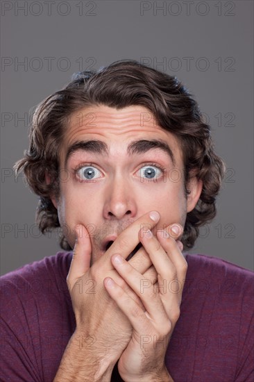 Studio shot of shocked young man. Photo : Rob Lewine