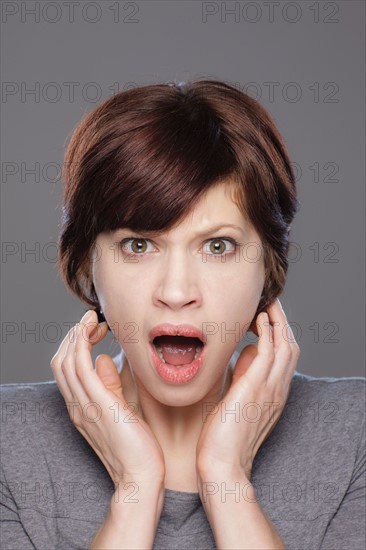 Studio shot of shocked young woman. Photo : Rob Lewine