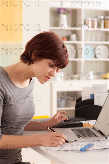 Young woman working at home. Photo : Rob Lewine