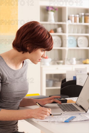 Young woman working at home. Photo : Rob Lewine