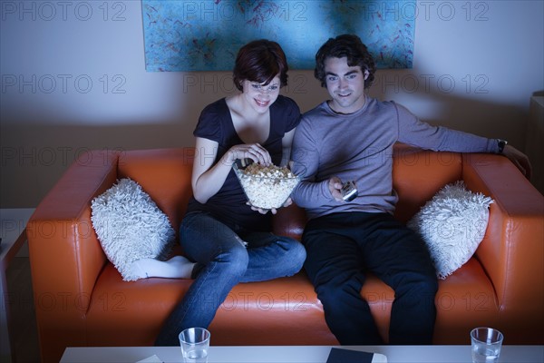 Young couple watching TV. Photo : Rob Lewine