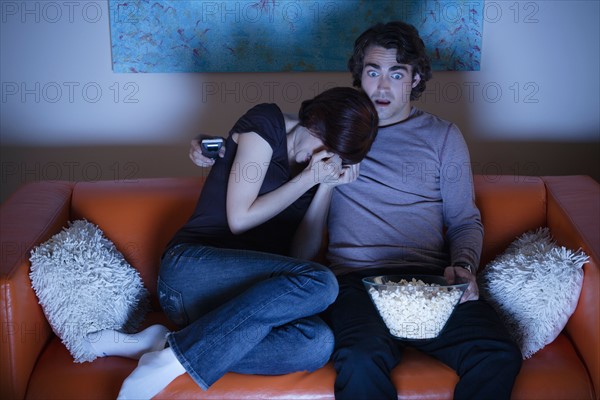 Young couple watching TV. Photo : Rob Lewine