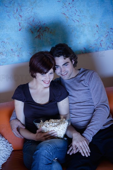 Young couple watching TV. Photo : Rob Lewine