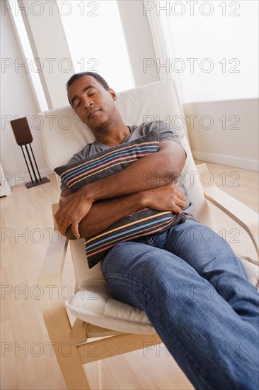 Mature man sleeping on armchair. Photo : Rob Lewine