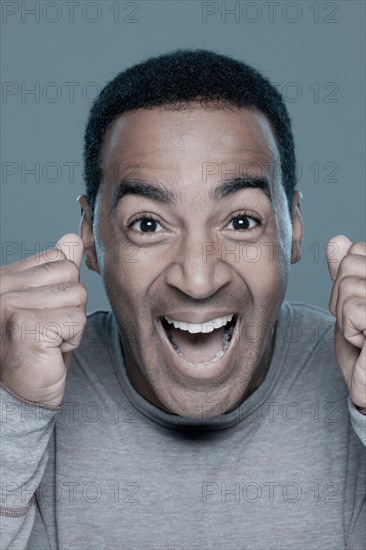 Studio shot of excited man. Photo : Rob Lewine