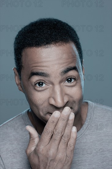 Studio shot of smiling man. Photo : Rob Lewine