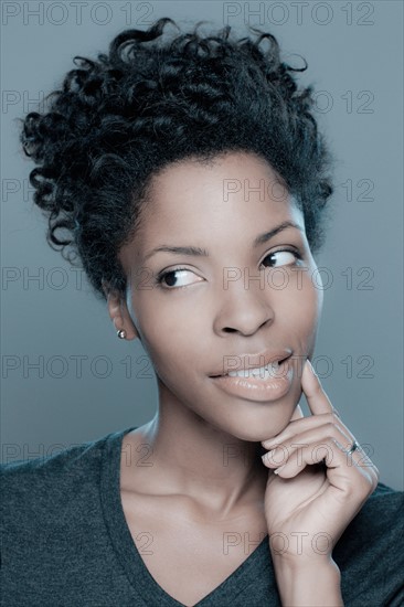 Studio shot of young woman smiling. Photo : Rob Lewine