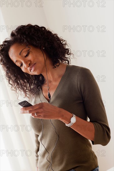 Mid adult woman listening music. Photo : Rob Lewine