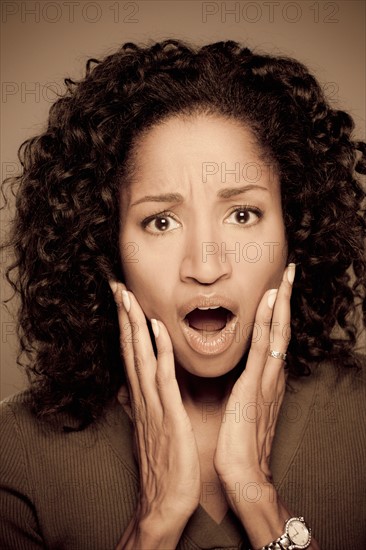 Studio shot of shocked mid adult woman. Photo : Rob Lewine