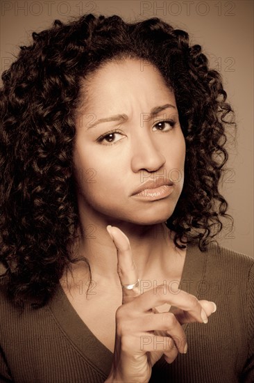 Studio shot of displeased mid adult woman. Photo : Rob Lewine