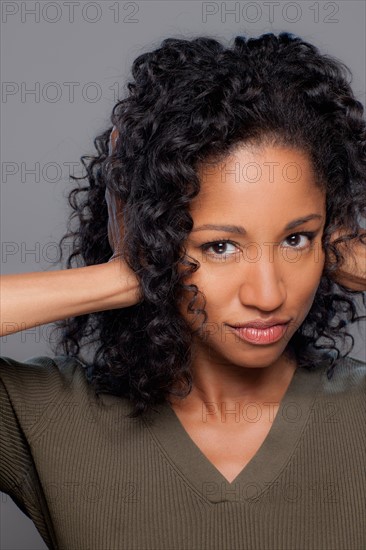 Studio shot of mid adult woman covering ears. Photo : Rob Lewine