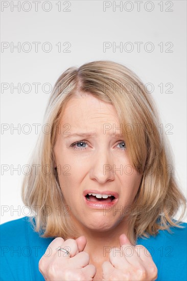 Studio shot of upset mid adult woman. Photo : Rob Lewine