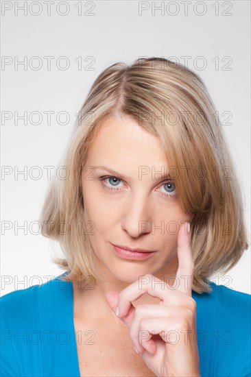 Studio shot of displeased woman gesturing. Photo : Rob Lewine