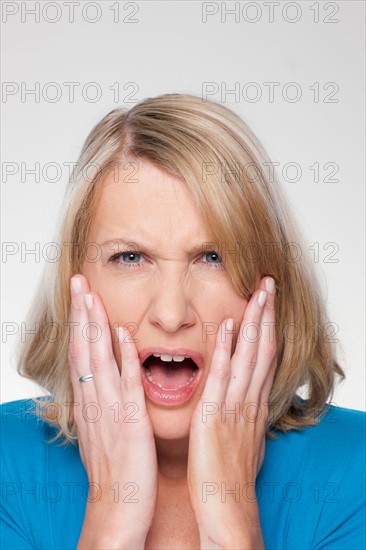 Studio shot of upset mid adult woman. Photo : Rob Lewine