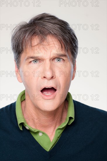 Studio shot of shocked mid adult man. Photo : Rob Lewine