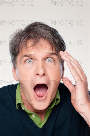 Studio portrait of mature man with facial expression. Photo : Rob Lewine