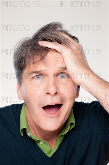 Studio portrait of mature man with facial expression. Photo : Rob Lewine