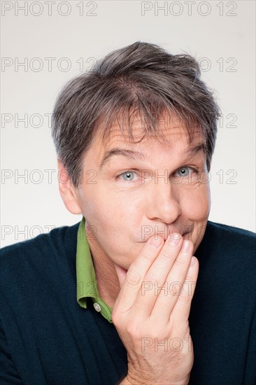 Studio portrait of mature man with facial expression. Photo : Rob Lewine