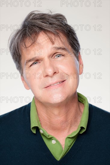 Studio portrait of mature man smiling. Photo : Rob Lewine