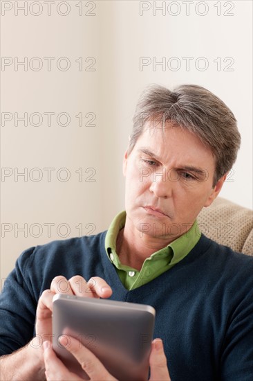 Man using digital tablet. Photo : Rob Lewine