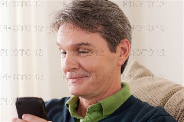 Man using phone. Photo : Rob Lewine