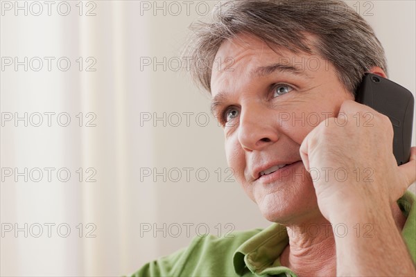 Man talking on phone. Photo : Rob Lewine