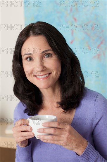 Portrait of mature woman drinking tea. Photo : Rob Lewine