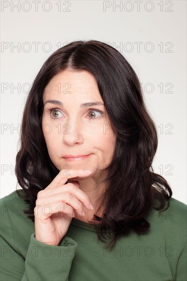 Studio portrait of mature woman with facial expression. Photo : Rob Lewine