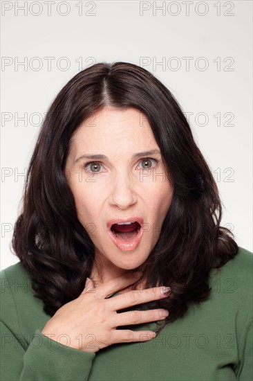 Studio portrait of mature woman with facial expression. Photo : Rob Lewine