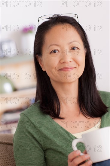 Portrait of woman holding cup. Photo : Rob Lewine