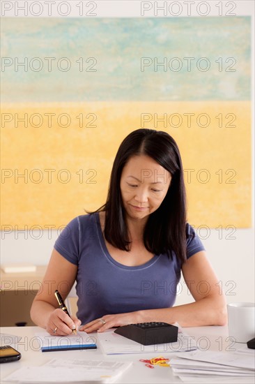 Woman doing paperwork. Photo : Rob Lewine