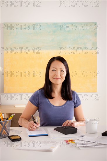 Portrait of woman doing paperwork. Photo : Rob Lewine