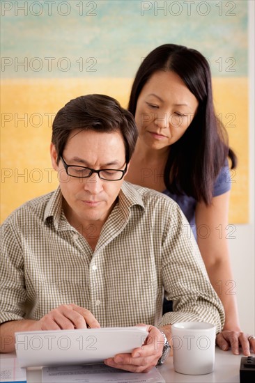 Couple doing paperwork. Photo : Rob Lewine