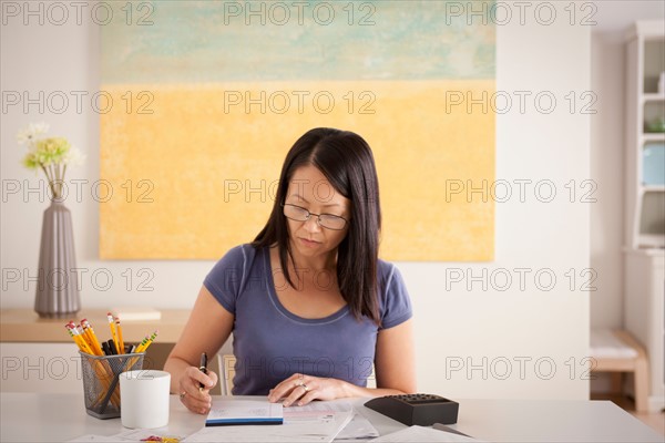 Woman doing paperwork. Photo : Rob Lewine