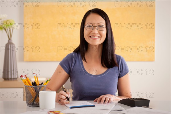 Portrait of woman doing paperwork. Photo : Rob Lewine