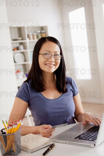 Portrait of woman shopping online from home. Photo : Rob Lewine