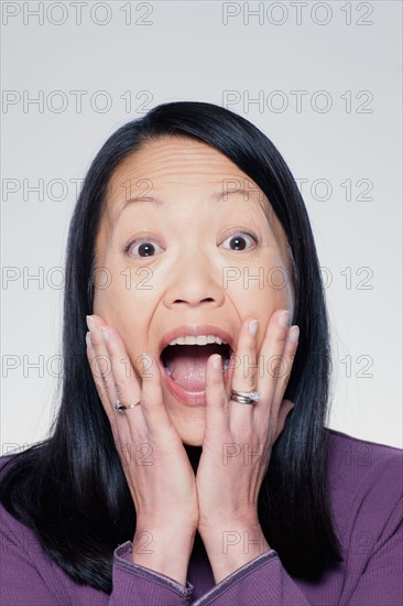 Studio portrait of mature woman screaming. Photo : Rob Lewine