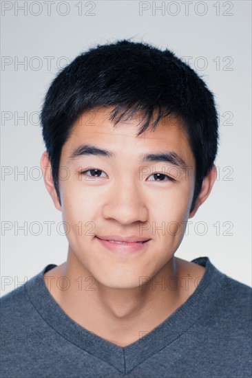 Studio portrait of young man smiling. Photo : Rob Lewine
