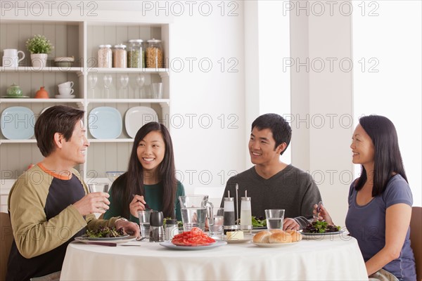 Happy family having meal together. Photo : Rob Lewine