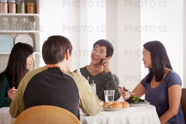 Happy family having meal together. Photo : Rob Lewine