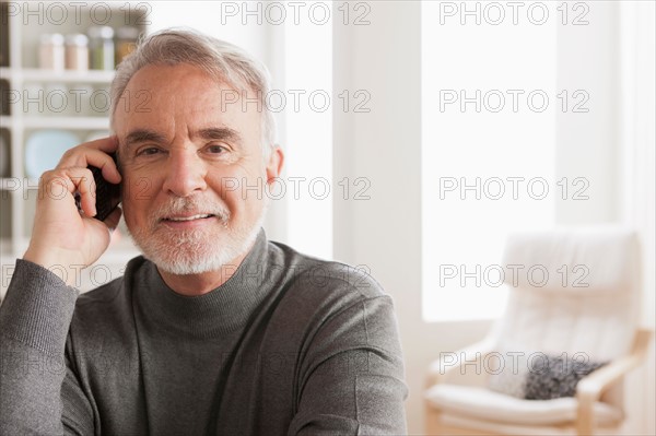 Portrait of smiling senior man talking via mobile. Photo : Rob Lewine