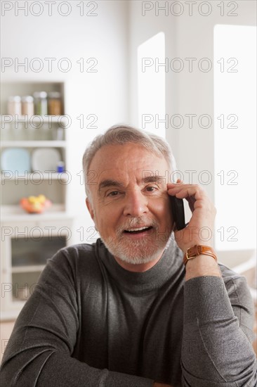Portrait of smiling senior man talking via mobile. Photo : Rob Lewine