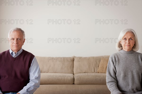 Portrait of senior couple sitting on sofa. Photo : Rob Lewine