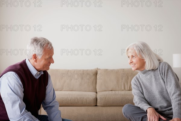 Portrait of senior couple sitting on sofa. Photo : Rob Lewine